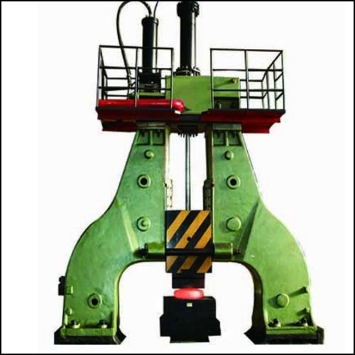 20 B Green hydraulic press or stamping machine with a red top guard and a yellow-black hazard block, used for industrial pressing.